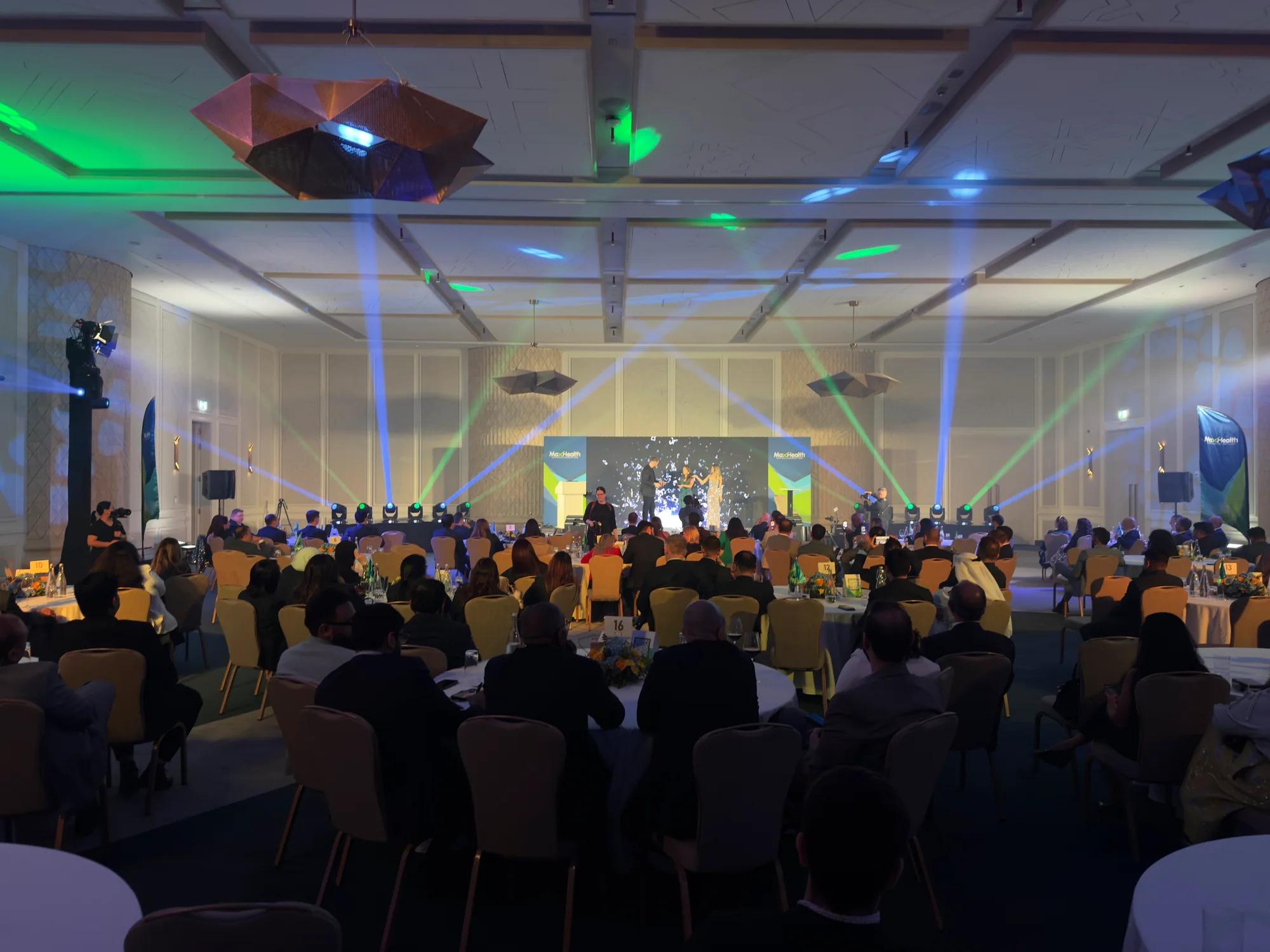 Conference production setup with stage lighting and projection