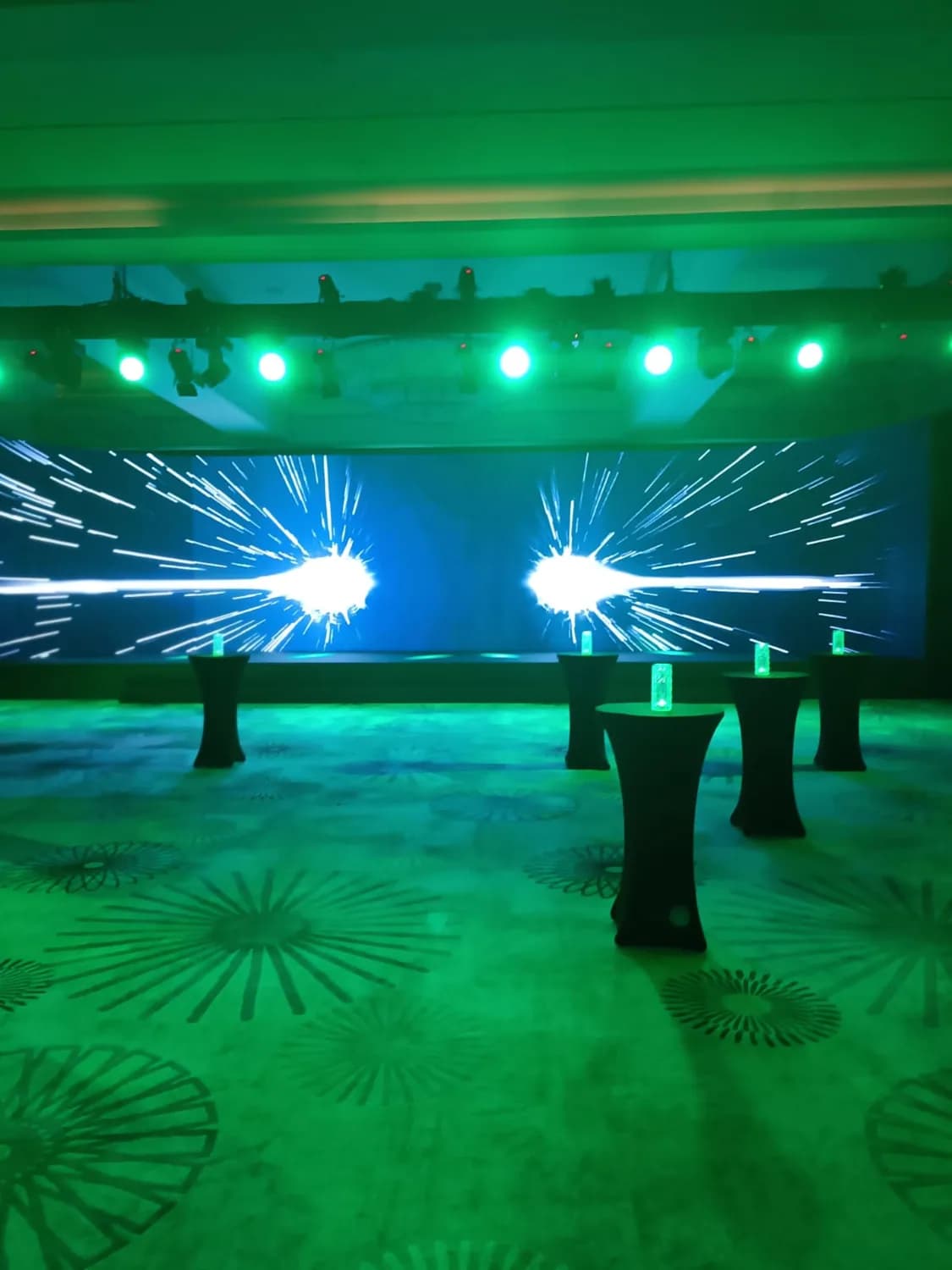 Conference stage prepared with a wide LED screen, lighting and floor setup