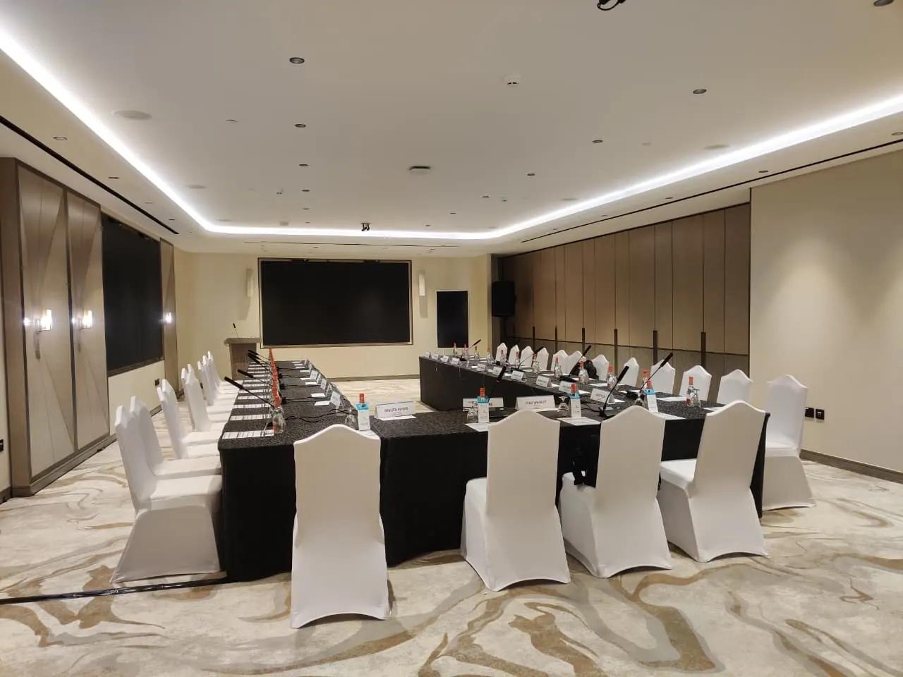 Representative corporate meeting room with delegate seating and a presentation screen