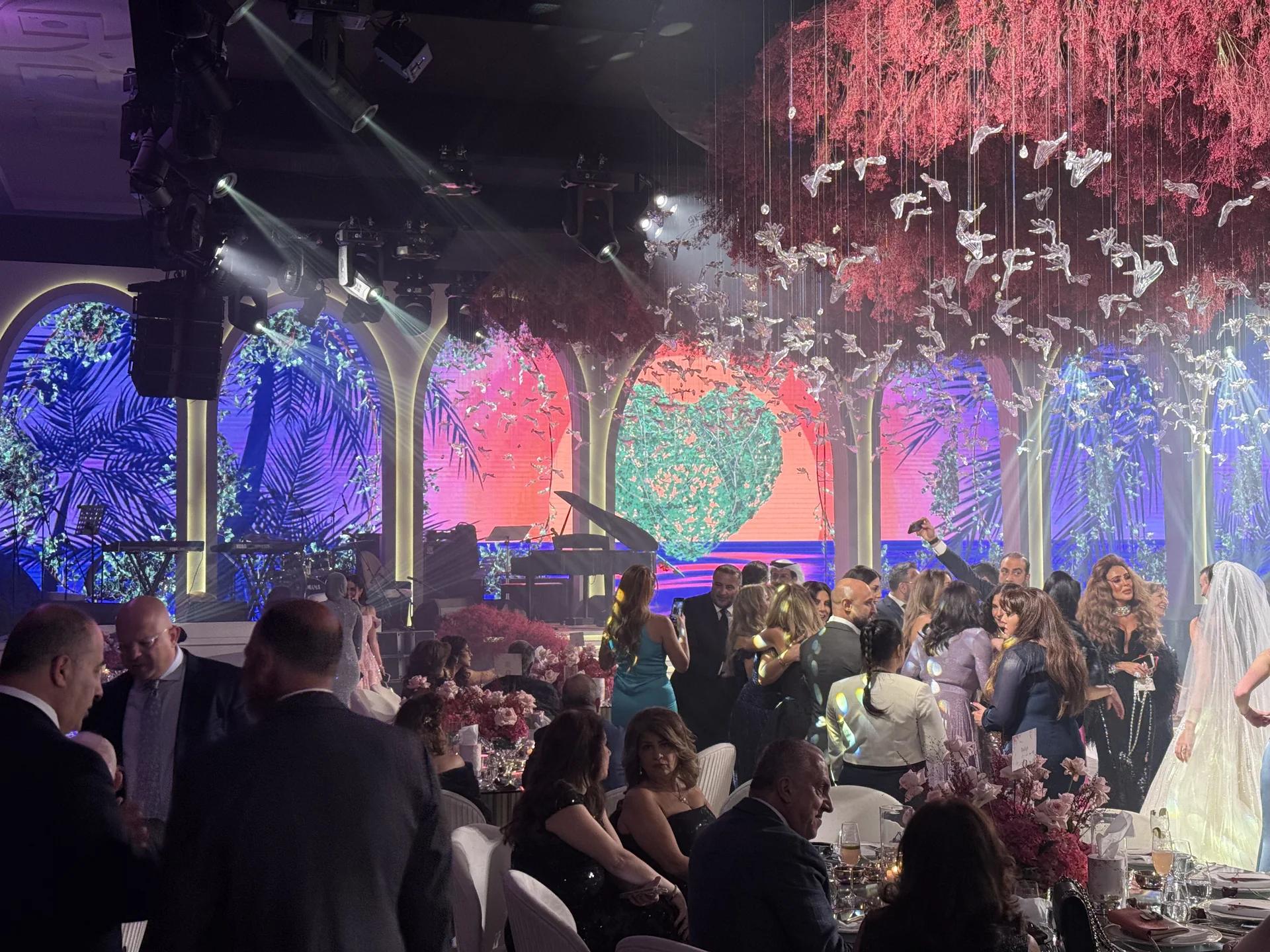 Private celebration with a live stage, suspended scenic details and guests