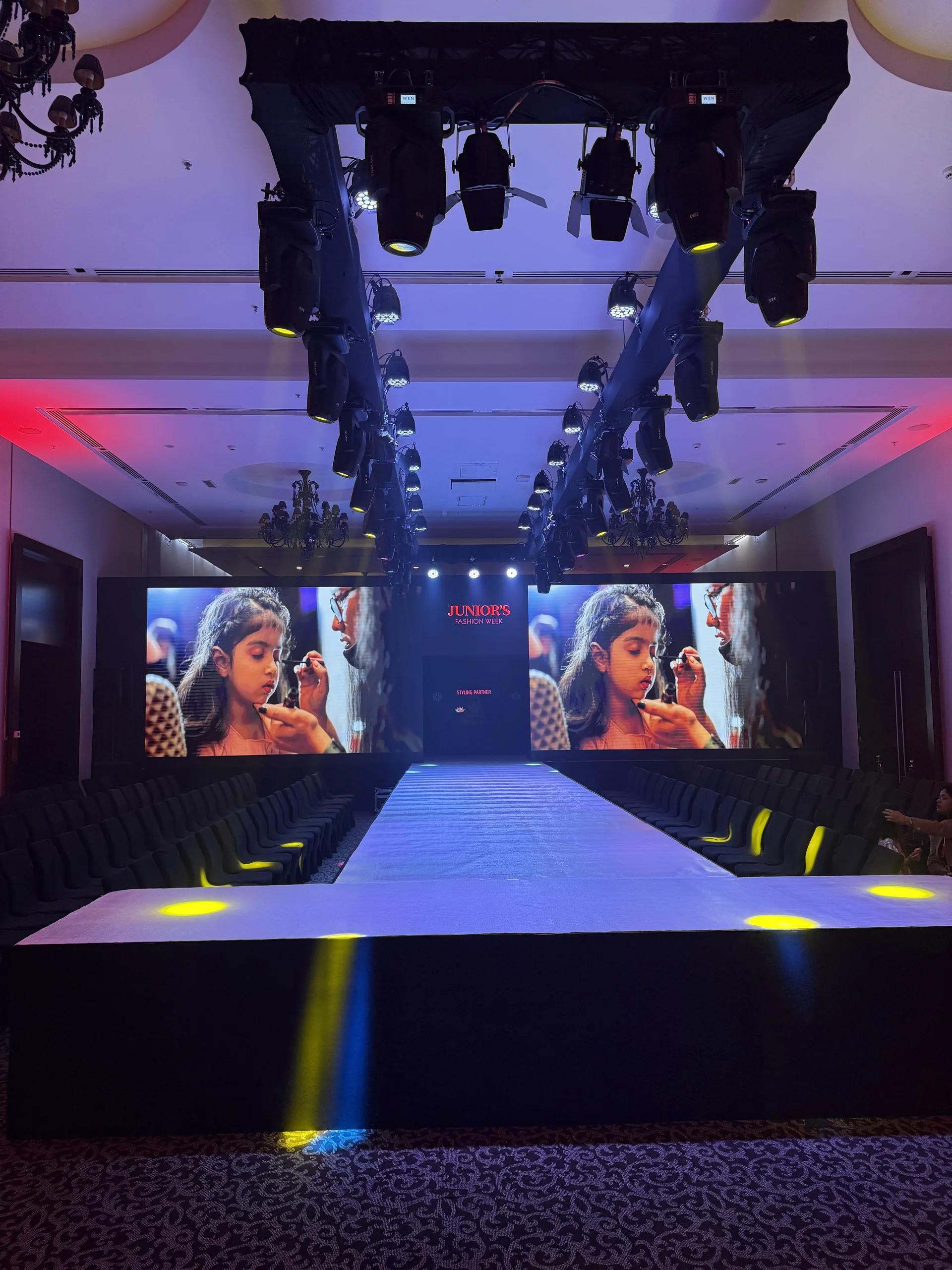 Runway environment with a wide LED backdrop, lighting truss and audience seating